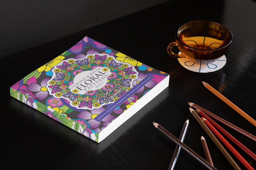 Coloring book Unwind and Relax Floral Patterns Book 1 by Sheri H. Designs and Sheri Hulan with pencil crayons and tea cup